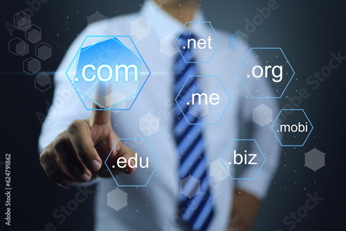 Fotografija Businessman hand specified to touch and choosen sub domain name to dot com or