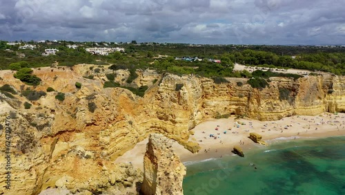 Praia da Marinha, beautiful beach Marinha in Algarve, Portugal. Navy Beach (Praia da Marinha) with flying seagulls over the beach, located on the Atlantic coast in Lagoa Municipality, Algarve.