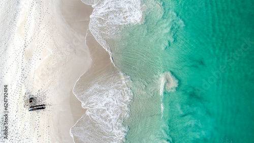 An aerial shot of a fisherman trying his luck in the ocean photo