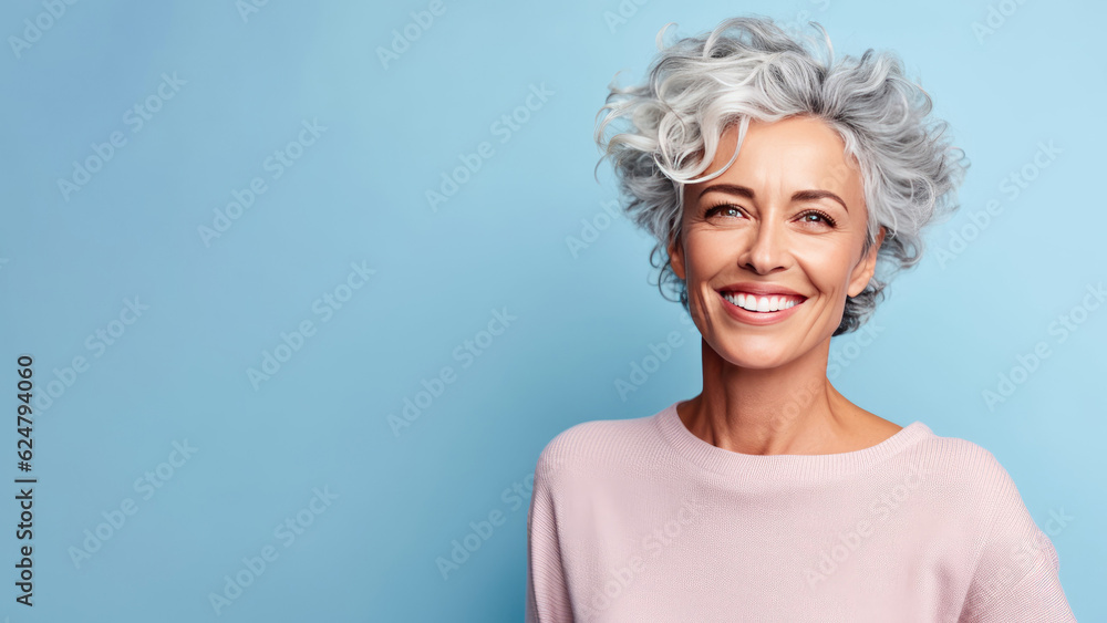 Smiling attractive woman 50s years old look to the camera, isolated on a plain blue background, studio portrait. People lifestyle concept. AI Generated.