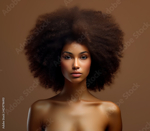 Young black woman with big afro hair, looking straight at you. 