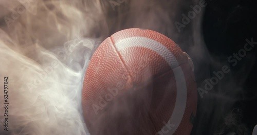 Football ball in studio with smoke anamorphic 4K