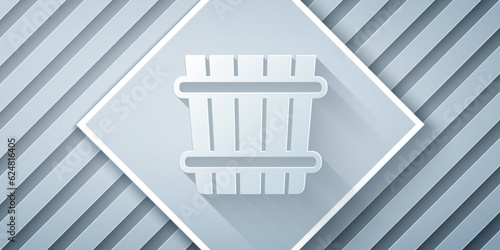 Paper cut Sauna bucket icon isolated on grey background. Paper art style. Vector