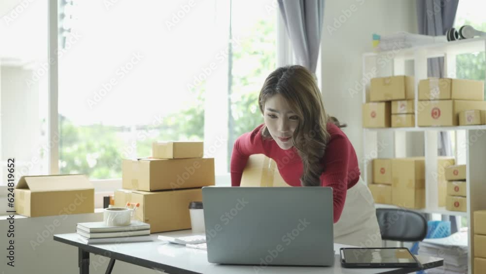 Happy successful asian businesswoman excited to receive purchase order and check stock Working at home office with parcel box laptop small business owner Online marketing, SME business concept Happy successful asian businesswoman excited to receive purchase order and check stock Working at home office with parcel box laptop small business owner Online marketing, SME business concept