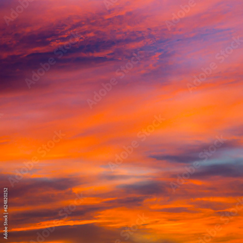 Vibrant orange red colours of sunset sky with clouds. Dramatic sky, light majestic sunset © katatonia
