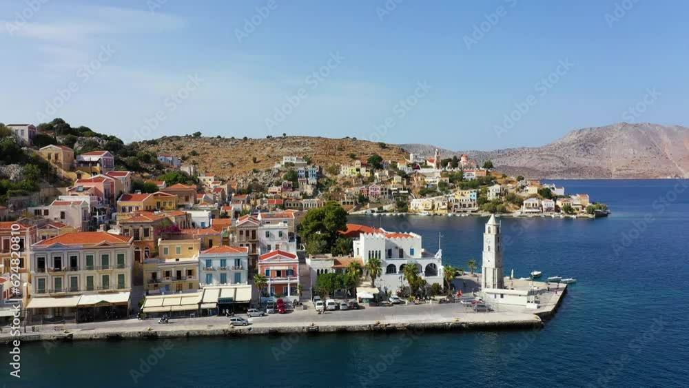 Aerial view of the beautiful greek island of Symi (Simi) with colourful houses and small boats. Greece, Symi island, view of the town of Symi (near Rhodes), Dodecanese. Aerial view of the beautiful greek island of Symi (Simi) with colourful houses and small boats. Greece, Symi island, view of the town of Symi (near Rhodes), Dodecanese.