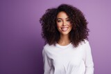 beautiful young woman standing on a purple background with curly hair and smiling, ai generated, white and purple, vibrant color combinations