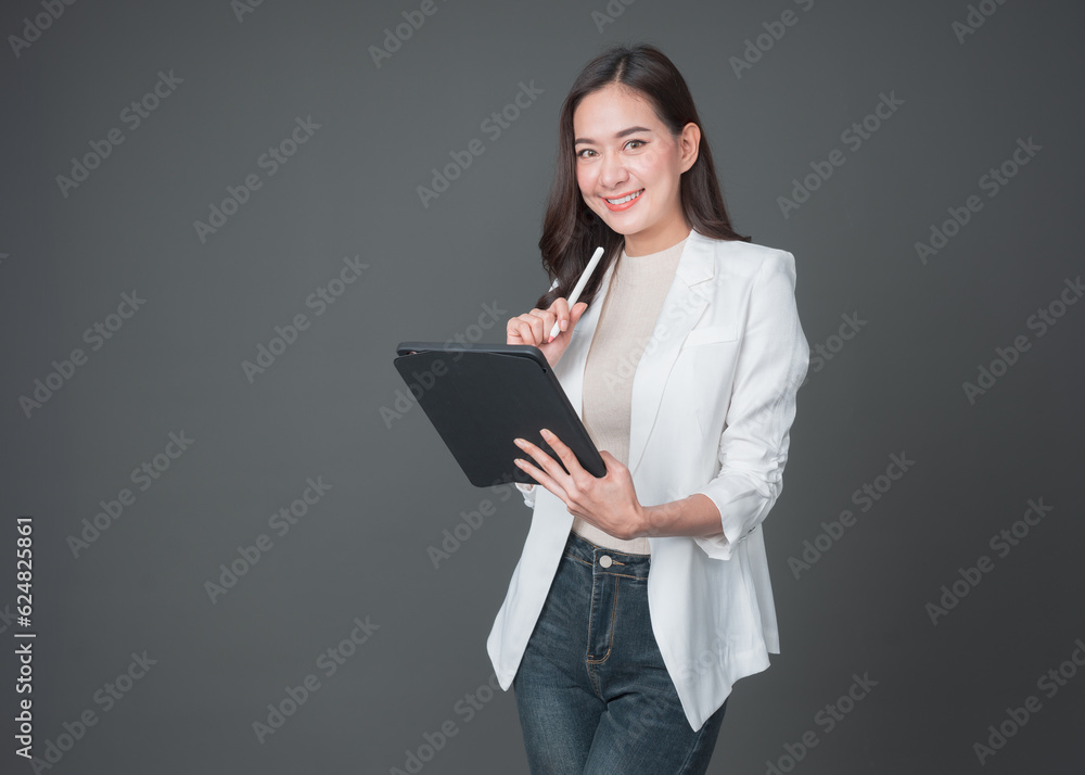 Young asian woman confident manager worker use modern technology digital tablet work remote distance isolated grey color background. Beautiful woman using smartphone. Lifestyle concept. Young asian woman confident manager worker use modern technology digital tablet work remote distance isolated grey color background. Beautiful woman using smartphone. Lifestyle concept.