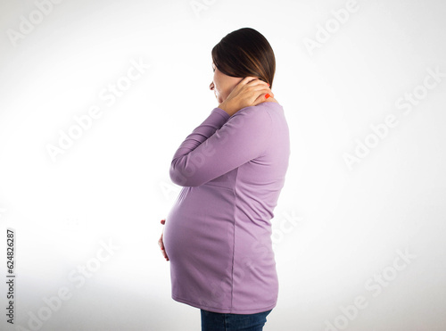 Neck pain in a pregnant girl in a purple blouse on a white background. The concept of osteochondrosis and protrusion of the cervical spine, exacerbation of neurological diseases during pregnancy.