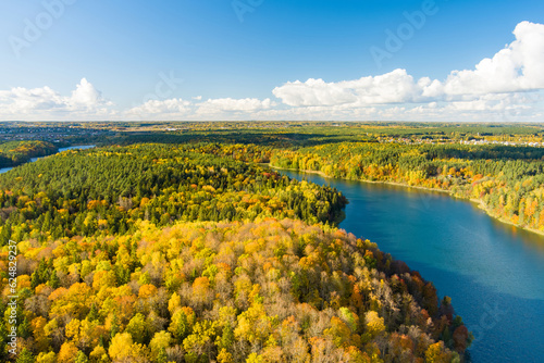 Aerial view of beautiful Balsys lake, one of six Green Lakes, located in Verkiai Regional Park. Birds eye view of scenic emerald lake surrounded by pine forests. Vilnius, Lithuania.