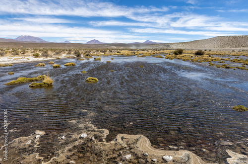 Off road traveling with a small river crossing in the remote Bolivian Andes between the famous lagoon route and Uyuni - Discovering South America