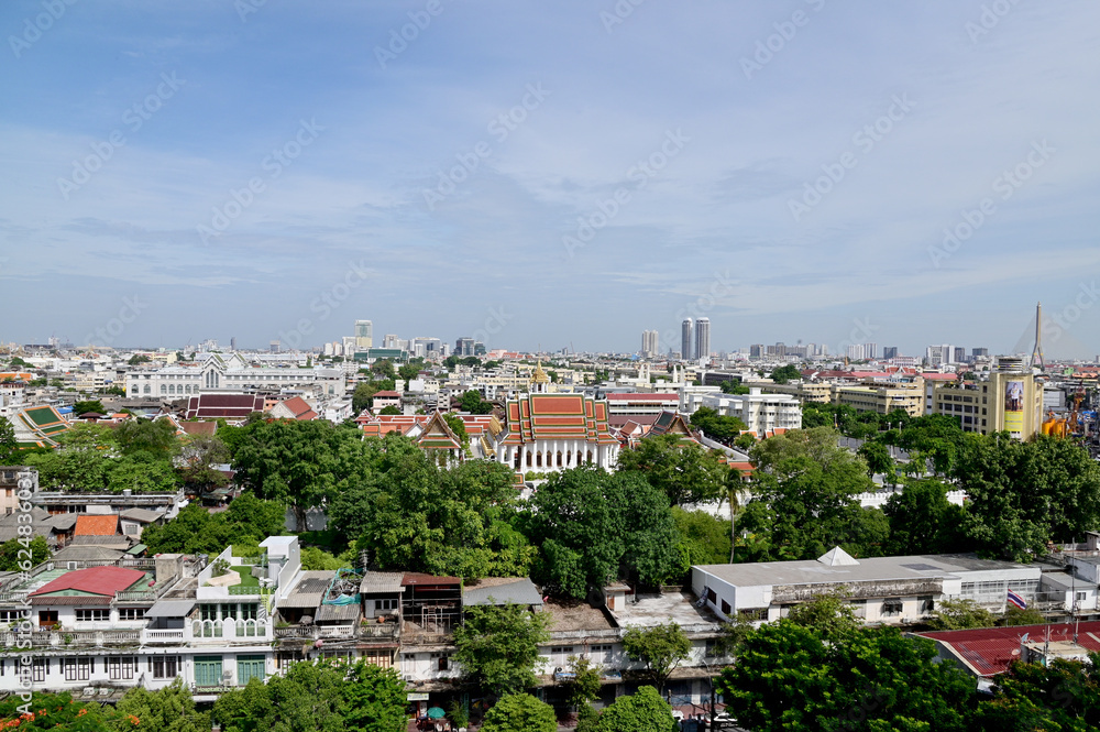 BANGKOK, THAILAND - July 22, 2023 : Landscape View of Bangkok City and Thai Buddhist Temple with Blue sky with white cloud. Clear day and good weather in the morning.