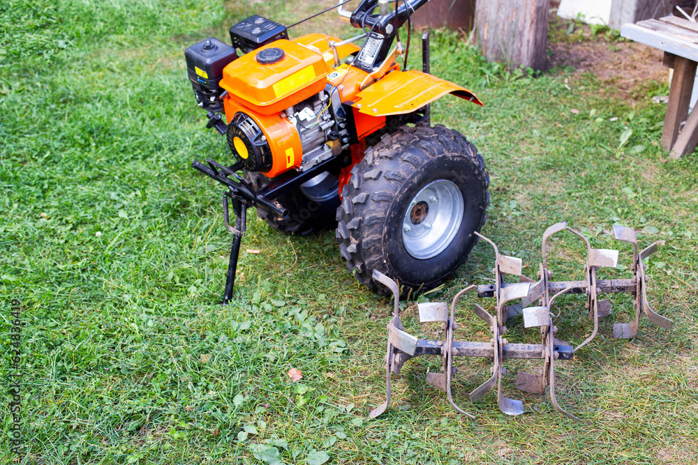 cutters complete with walk-behind tractor for work on the ground. Technique for agriculture. Motor cultivator. Copy space for text cutters complete with walk-behind tractor for work on the ground. Technique for agriculture. Motor cultivator. Copy space for text