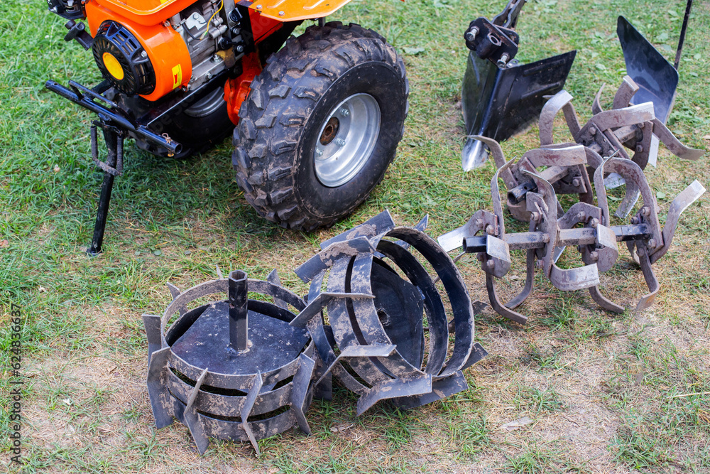 Obraz premium A set of attachments, hiller, milling cutters and lugs. Motoblock for agricultural work. Purchase and running-in of a motor cultivator.