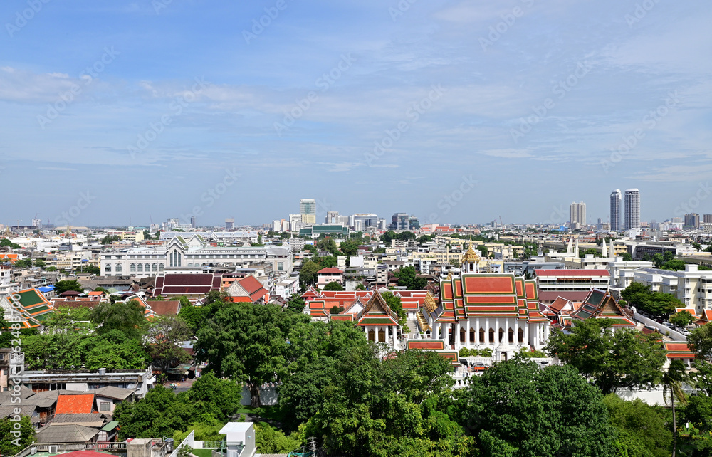 Fototapeta premium BANGKOK, THAILAND - July 22, 2023 : Landscape View of Bangkok City and Thai Buddhist Temple with Blue sky with white cloud. Clear day and good weather in the morning.