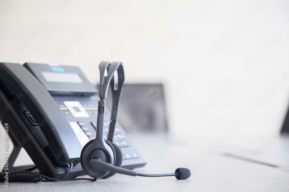 Communication support, call center and customer service help desk. VOIP headset on telephone keyboard. Communication support, call center and customer service help desk. VOIP headset on telephone keyboard.