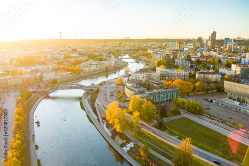 Beautiful Vilnius city panorama in autumn with orange and yellow foliage. Aerial evening view.