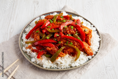 Homemade Simple Chili Chicken with Rice on a Plate, side view.