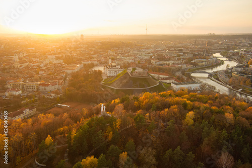 Fototapeta Naklejka Na Ścianę i Meble -  Beautiful Vilnius city panorama in autumn with orange and yellow foliage. Aerial evening view.