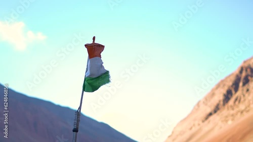 Indian flag waving in front of the snow covered mountains in Padum town in Kargil District at Zanskar Valley, Ladakh, India. Indian flag waves in the kargil district in front of snowy Himalayas. photo