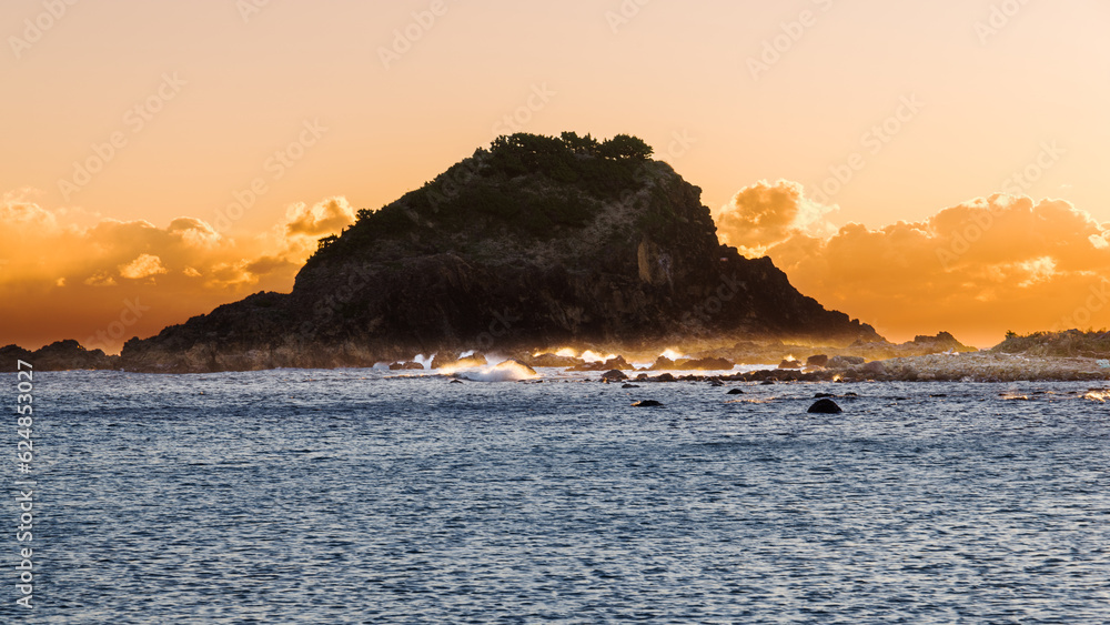 Silhouette of Island and Crashing Waves