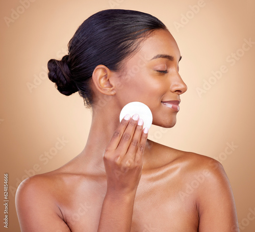 Fototapeta Woman, cotton pad and skincare of face cosmetics for aesthetic wellness on studio background