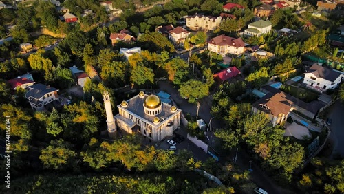 Mosque at sunrise agains the mountains in Almaty photo