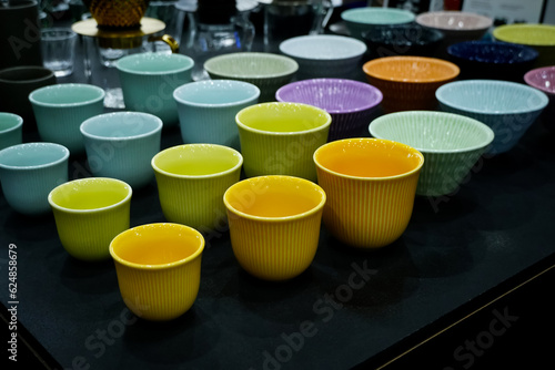 Colorful handmade ceramic cups on black table for sale