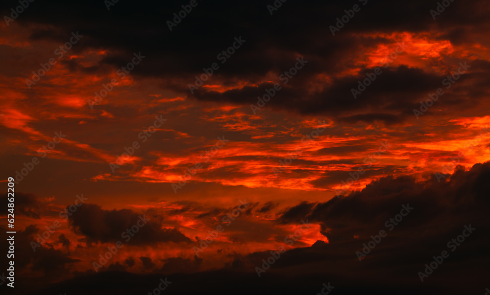 Dramatic sunset sky with red and black clouds