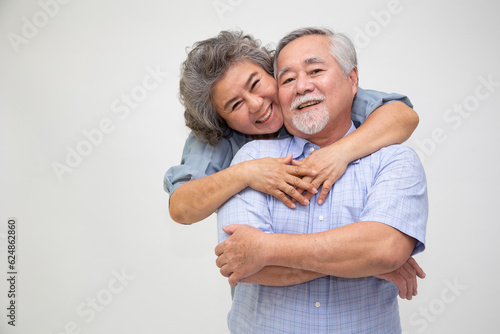 Asian senior couple hugging together isolated over white background, In love anniversary concept