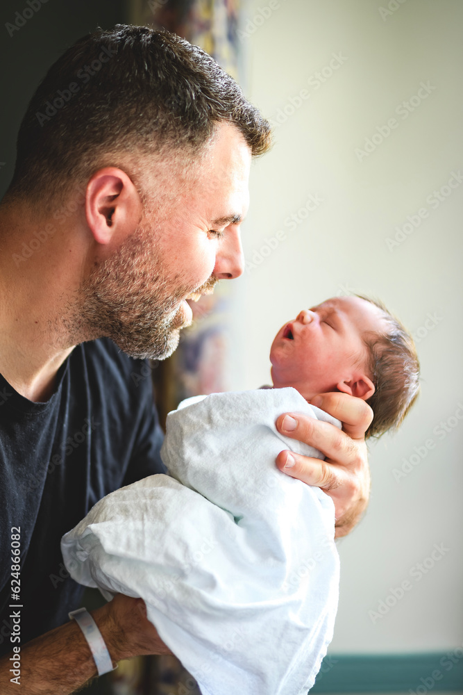 New born baby boy resting in father arms New born baby boy resting in father arms