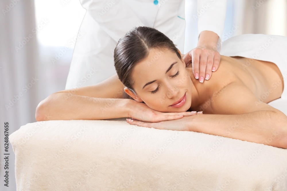 Beautiful young Woman Enjoying Massage In Salon Beautiful young Woman Enjoying Massage In Salon