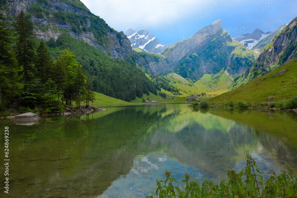 Picturesque Seealpsee, an idyllic alpine lake in the Alpstein range of the canton of Appenzell Innerrhoden, Switzerland.
