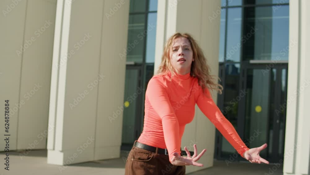 Young woman dancing hip hop elegant dance on high heels. Redhead curly girl dance Modern Jazz Funk choreography. Female professional dancer showing dance movings. Musical video. Young woman dancing hip hop elegant dance on high heels. Redhead curly girl dance Modern Jazz Funk choreography. Female professional dancer showing dance movings. Musical video.