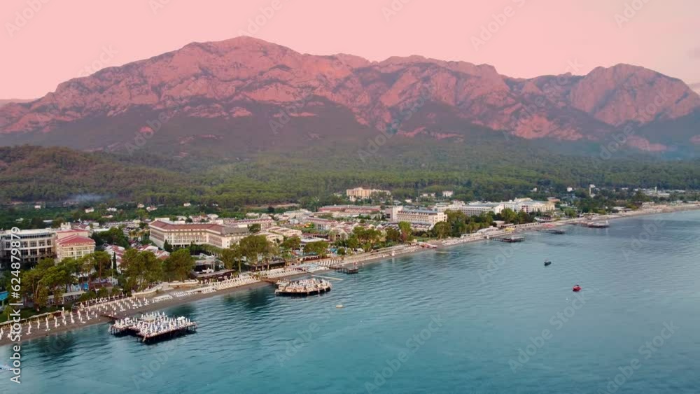 beauty of Kemer from a new perspective with breathtaking aerial view, showcasing a stunning panorama of hotels nestled amidst the scenic mountain landscape.