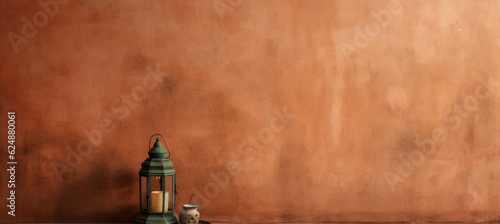 Old terracotta wall with lantern on wood table and empty space on design side