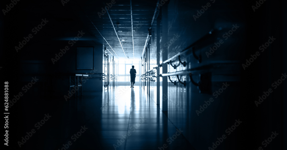 People walking in hospital corridor People walking in hospital corridor