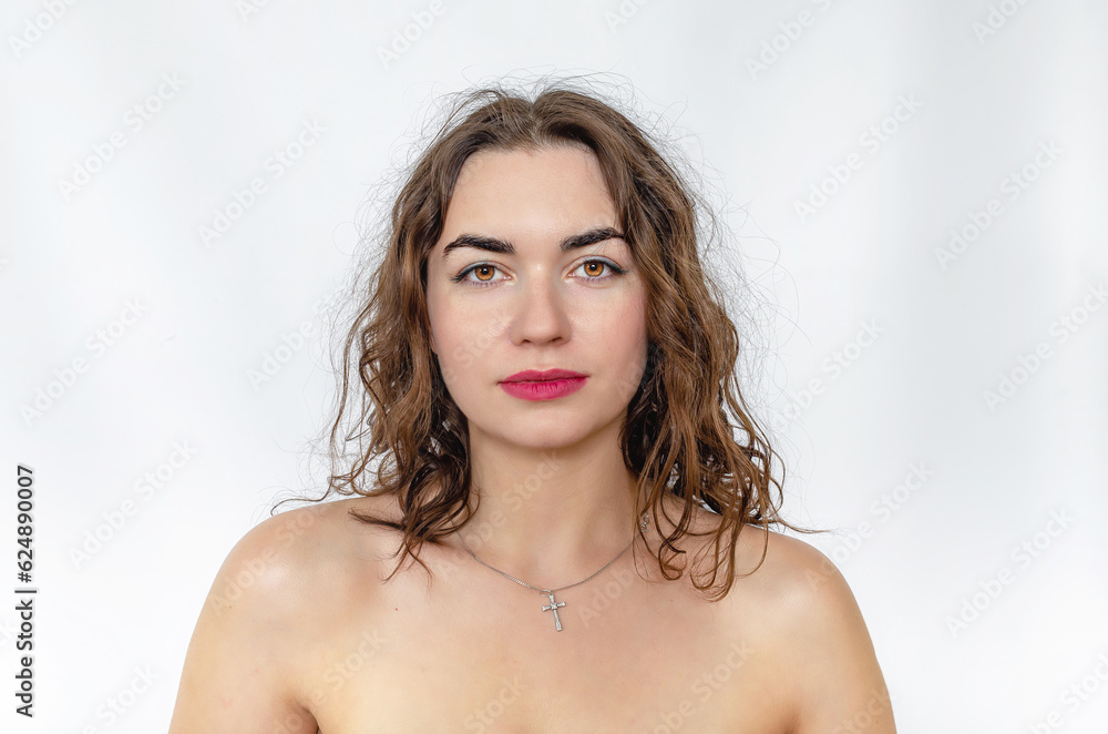 Portrait of woman with bare shoulders. Wavy dark hair, black eyebrows, brown eyes. Portrait of woman with bare shoulders. Wavy dark hair, black eyebrows, brown eyes.