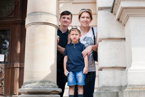Fotografie A family on an excursion in a big city - a little boy, dad and mom, the boy is t