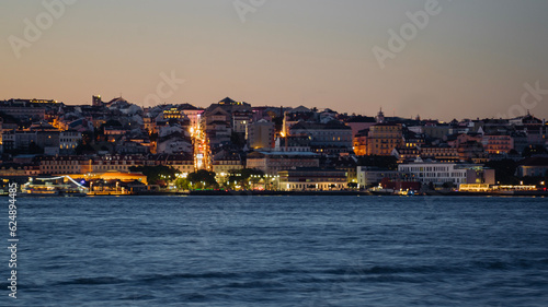 View of Lisbon city from Cacilhas at dusk; Concept for travel in Portugal and visit Lisbon