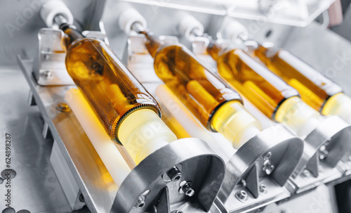 Disinfection and pasteurization process of glass bottles for bottling beer. Brewery factory plant production line