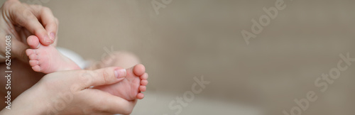 Banner, baby legs in mother's hands.A mother's love for her child. Maternity leave, maternity, care. Children's Day, photo