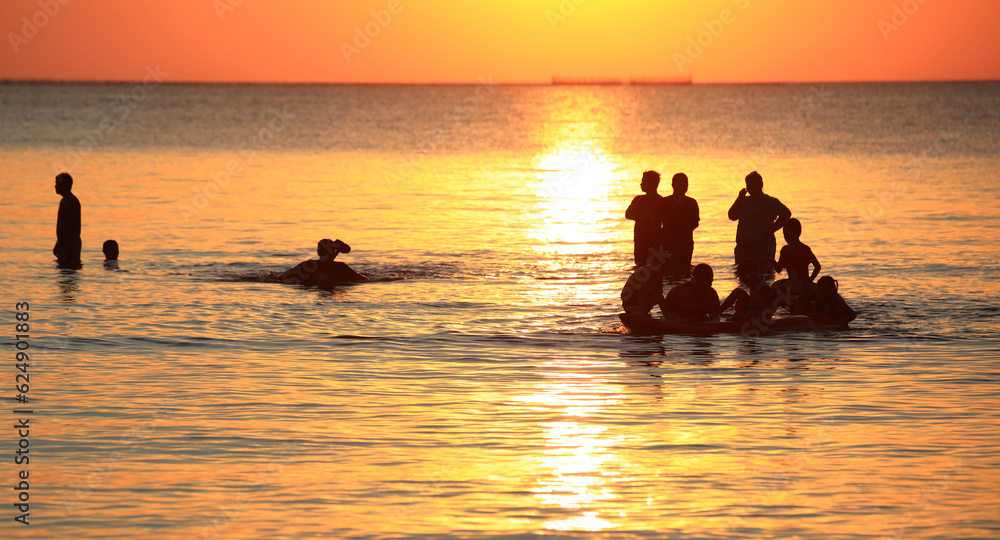 Outdoor summer vacation, groups of tourism play water in the sea.
