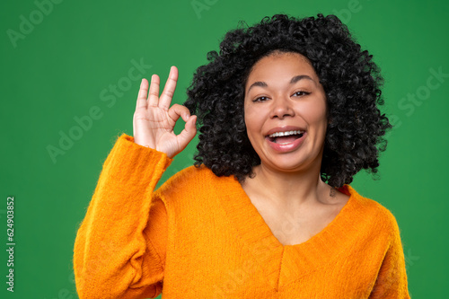 Happy dark-haired ypung woman in orange photo