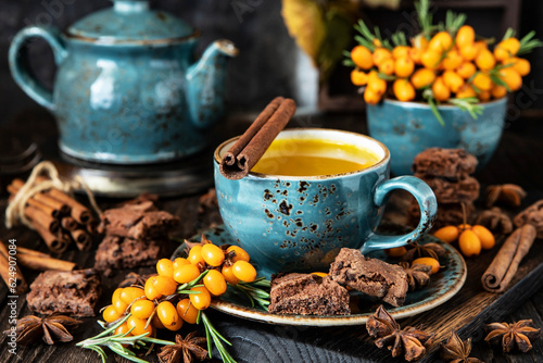 Ceramic  cup of sea buckthorn tea on  dark background