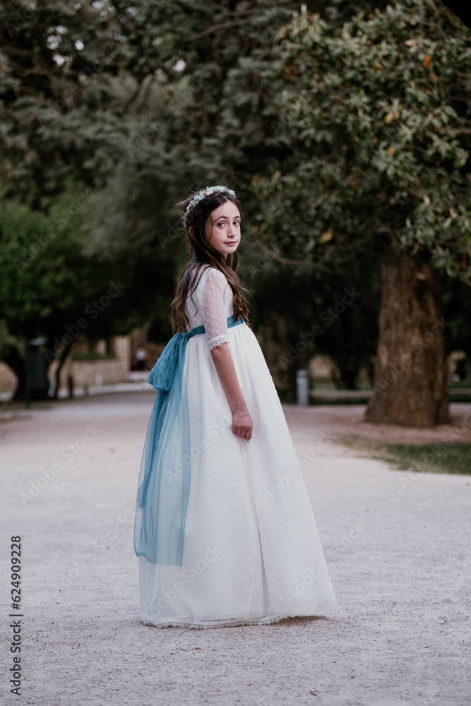 Elegant girl in white dress standing in park Elegant girl in white dress standing in park