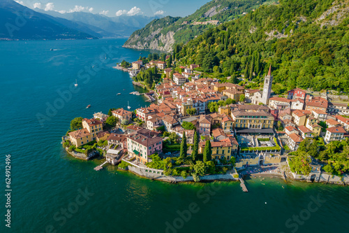 Varenna, Como Lake. Aerial panoramic view of town surrounded by mountains, blue sky and turquoise water and located in Como Lake, Lombardy, Italy © Audrius