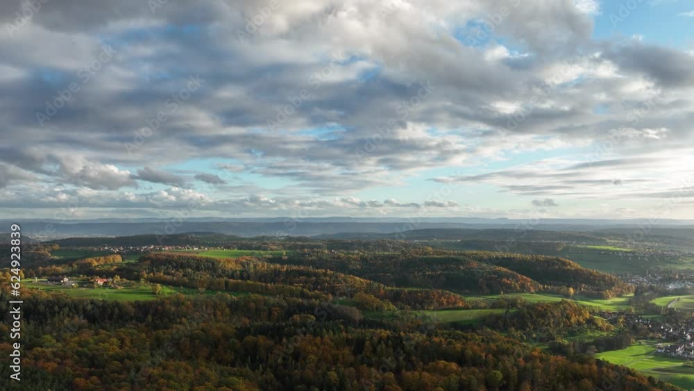 Hyperlapse drone view of sundown over forest and rural landscape in autumn, region Swabian Forest, Baden-Wuerttemberg, Germany, Europe Hyperlapse drone view of sundown over forest and rural landscape in autumn, region Swabian Forest, Baden-Wuerttemberg, Germany, Europe