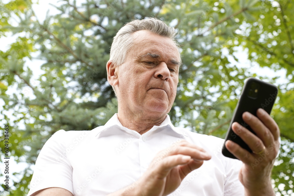 Senior caucasian man using smartphone for calls, social media, mobile application online Senior caucasian man using smartphone for calls, social media, mobile application online