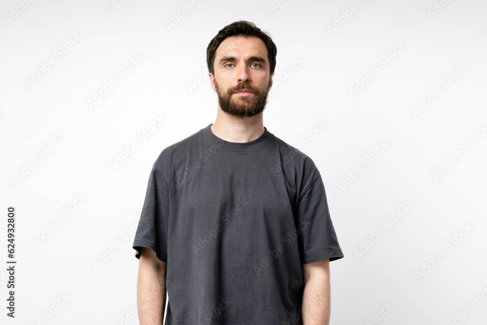 Portrait of confident handsome middle aged caucasian bearded man, wearing gray t shirt, looking confidently at camera isolated on white background. Mockup Portrait of confident handsome middle aged caucasian bearded man, wearing gray t shirt, looking confidently at camera isolated on white background. Mockup
